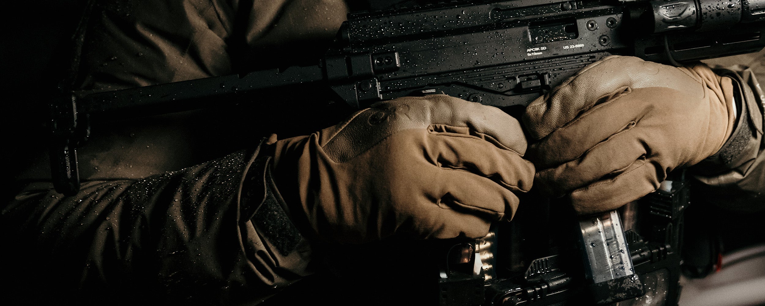 Close up of a person in tactical gear wearing Outdoor Research gloves.