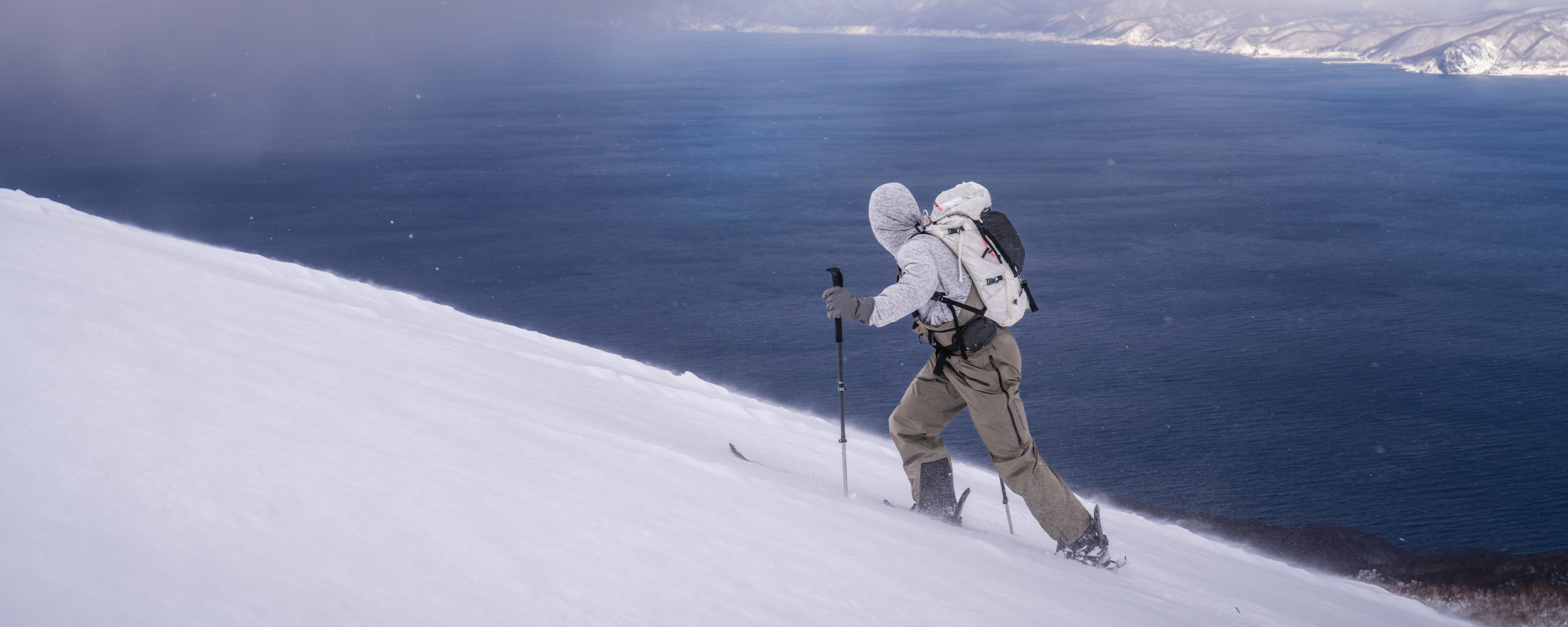 Skier in ski bibs in the deep powder snow