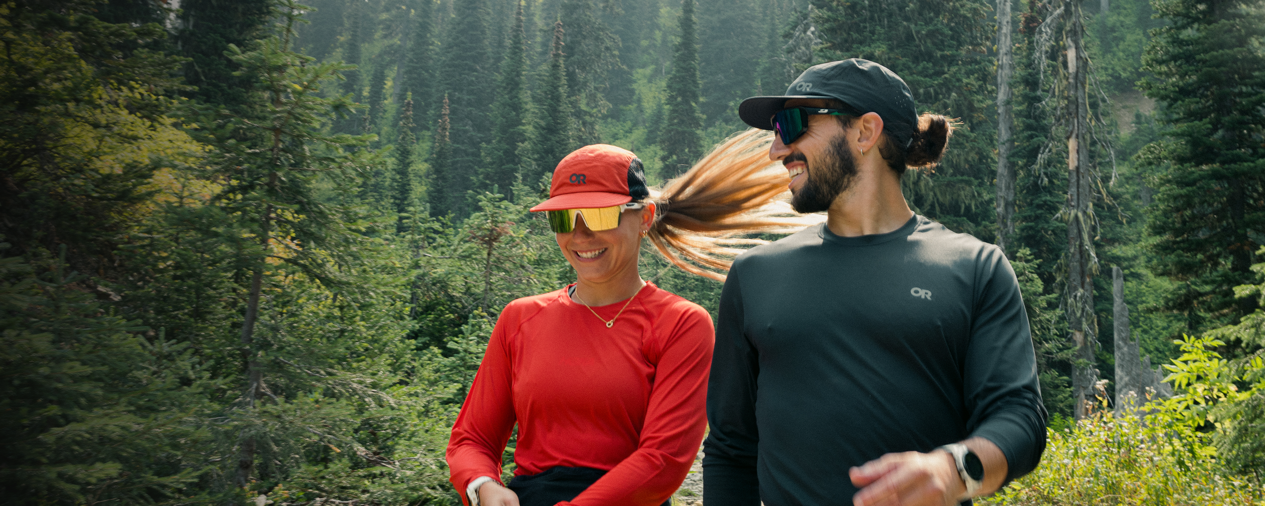 Two people walking on the trail wearing Outdoor Research ActiveIce and Echo Long Sleeve Tees. 