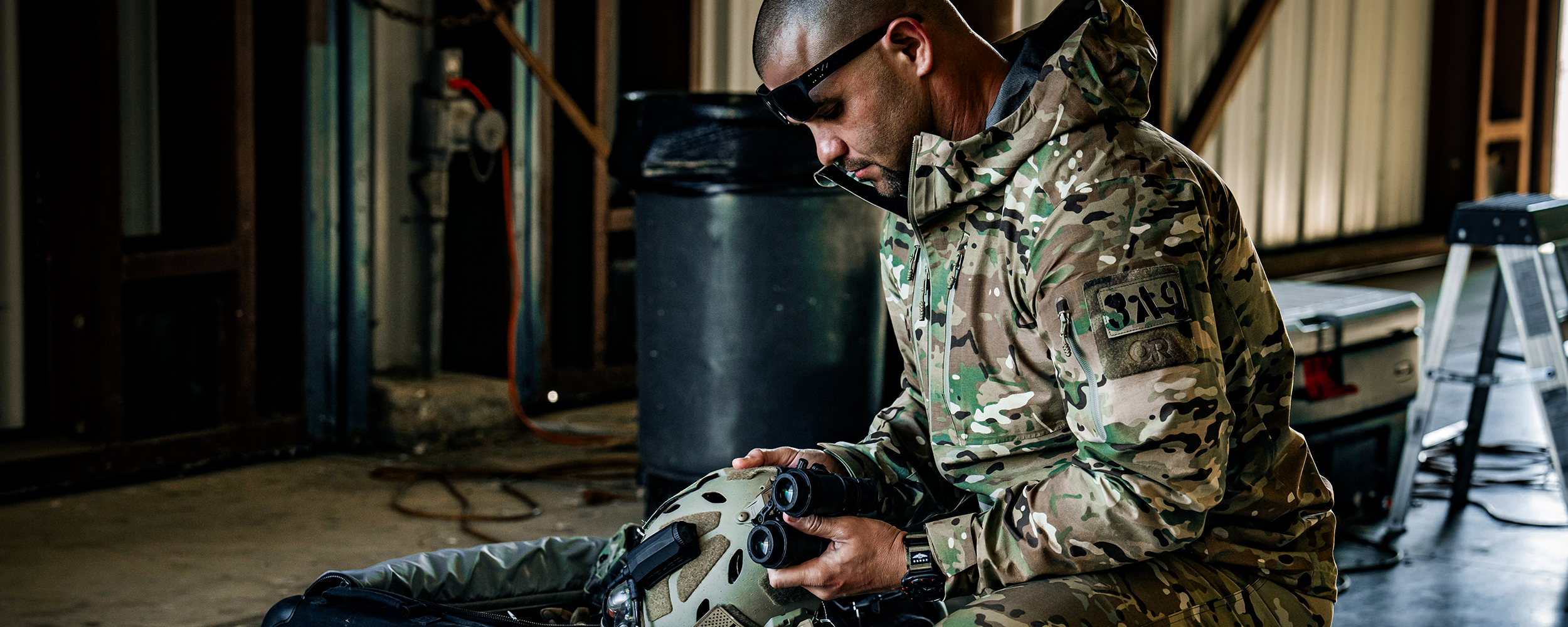 A man wears OR Tactical outerwear while out on a boat.