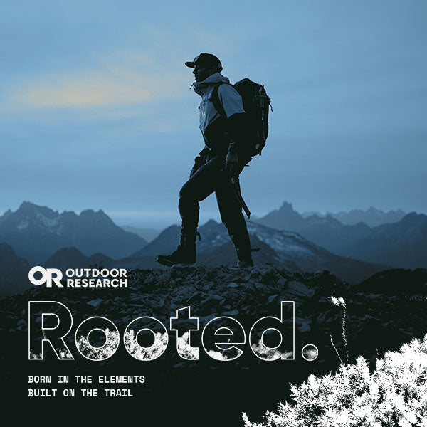 Graphic of a man standing atop a mountain, with the Outdoor Research logo and the words Rooted. with "born in the elements built on the trail" underneath.