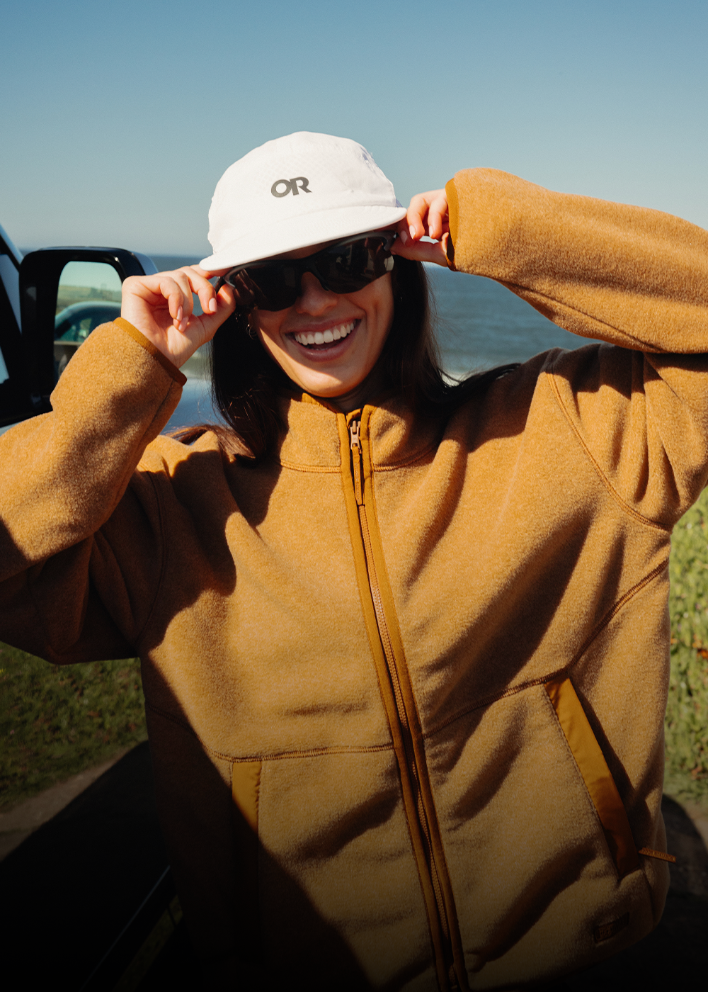 Women wearing Outdoor Research fleece jacket by the ocean