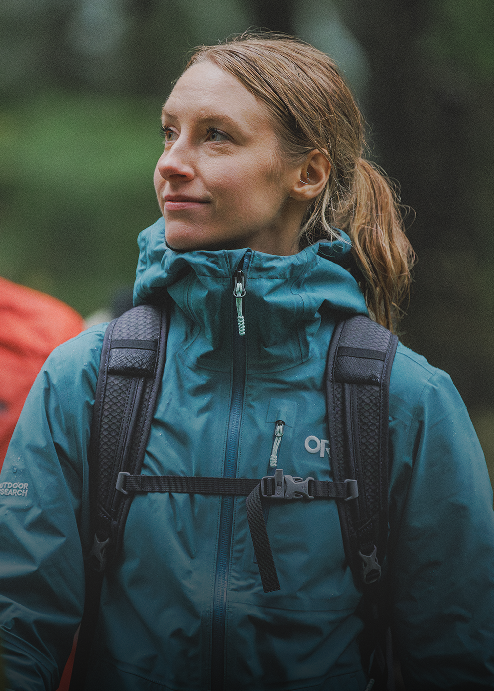 Female walking with two others wearing Outdoor Research Women's Aspire 3L Jacket Mallard. 