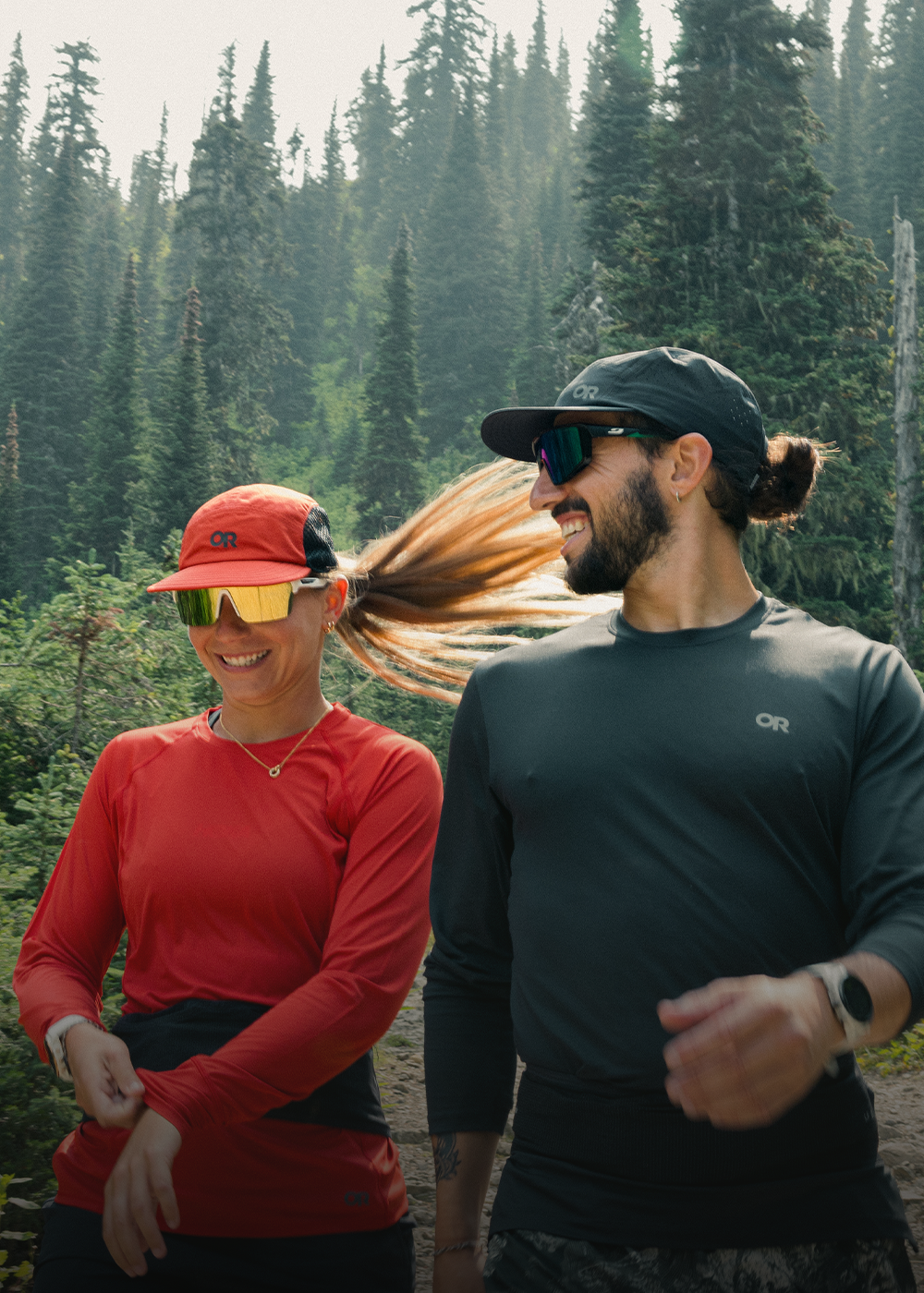 Two people walking on the trail wearing Outdoor Research ActiveIce and Echo Long Sleeve Tees. 