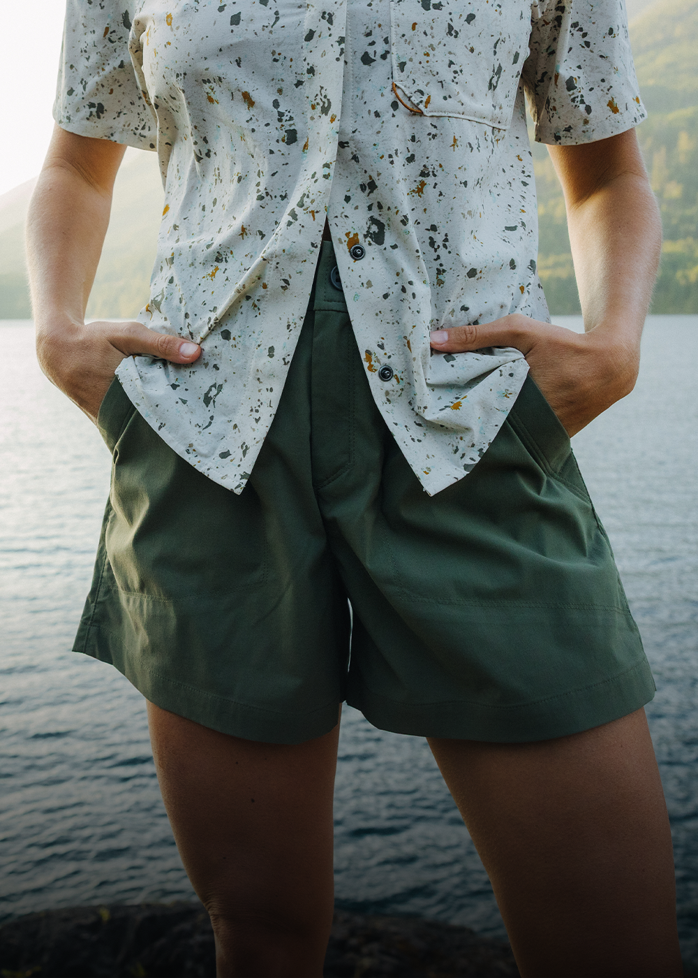 A woman puts her hand in the pocket of her Outdoor Research shorts.